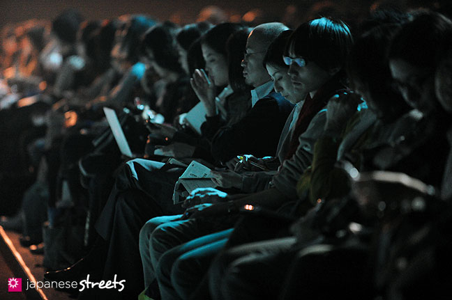 111019-8916: Visitors wait for a show to start at the Japan Fashion Week in Tokyo
