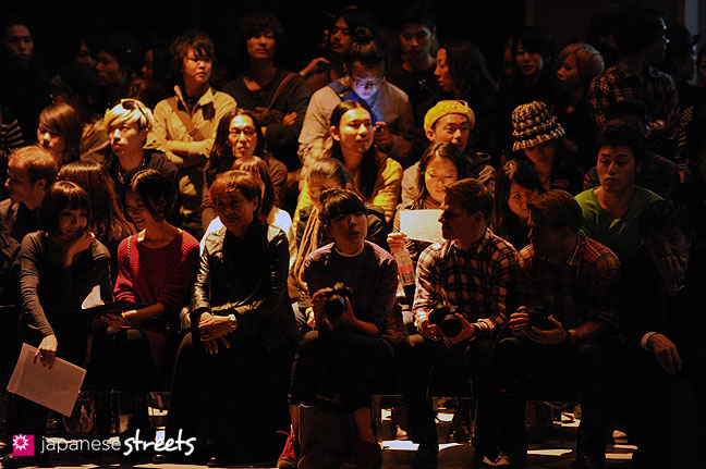 111020-0389: Visitors wait for a show to start at the Japan Fashion Week in Tokyo
