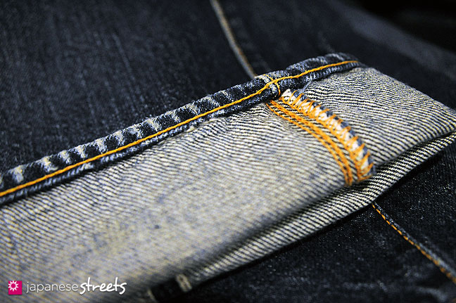 101105-6668 - Detail of the hemline of used EVISU jeans. The fading is interrupted at regular intervals, creating a playful display. “That only happens when you use a chain stitch,” explains owner Yamane.